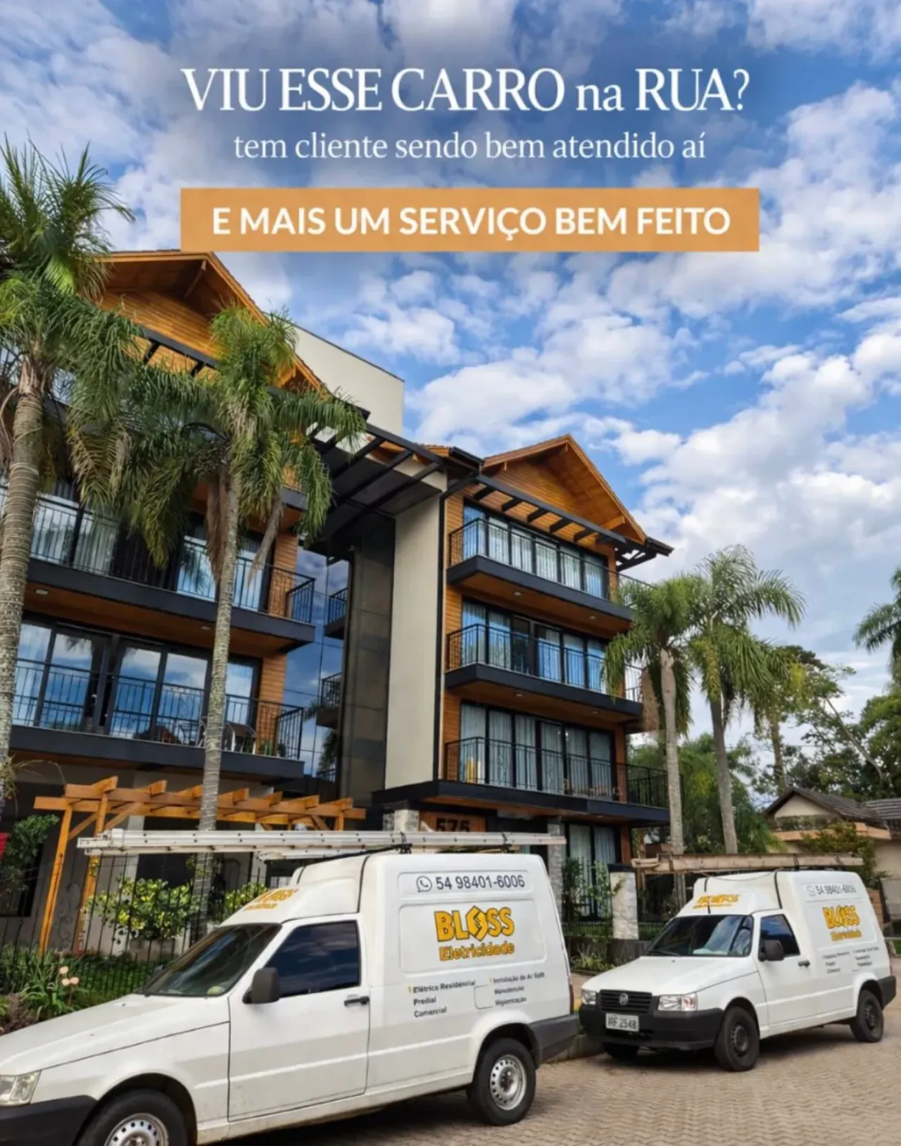 Edificação com dois veículos identificados da Bloss Eletricidade em frente.
